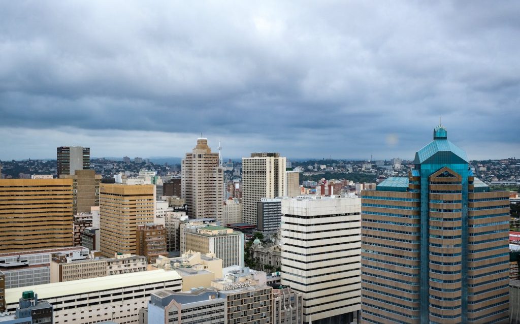 A stunning aerial view of Durbans modern skyline with high-rise buildings and an overcast sky.